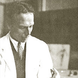Black-and-white photograph of a doctor in a white coat