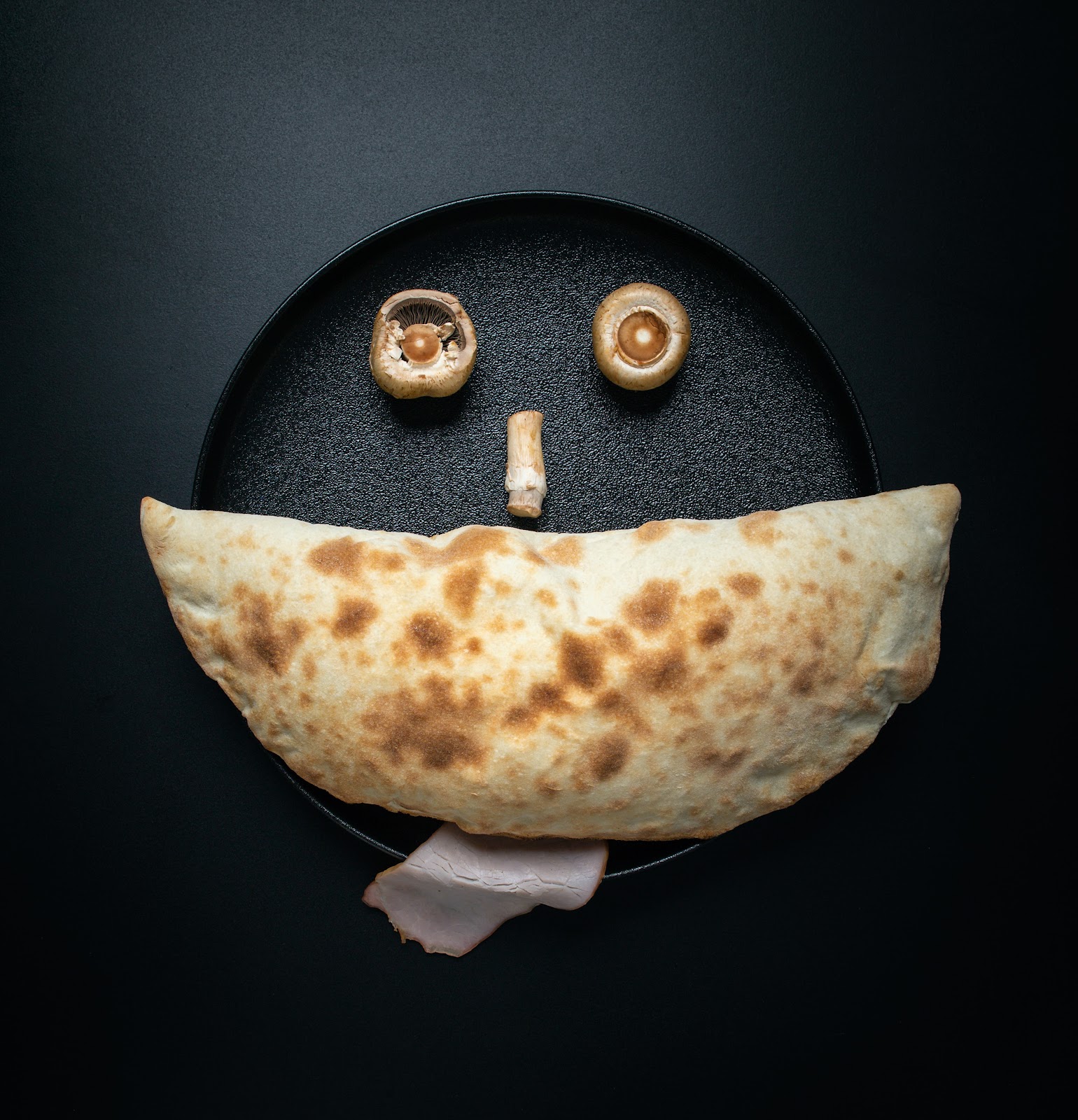 A folded low-carb meal arranged as a smiling face