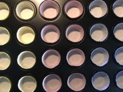 muffin cups lined up in a mini muffin pan