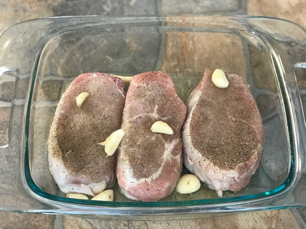 seasoned pork chops getting ready to go into oven