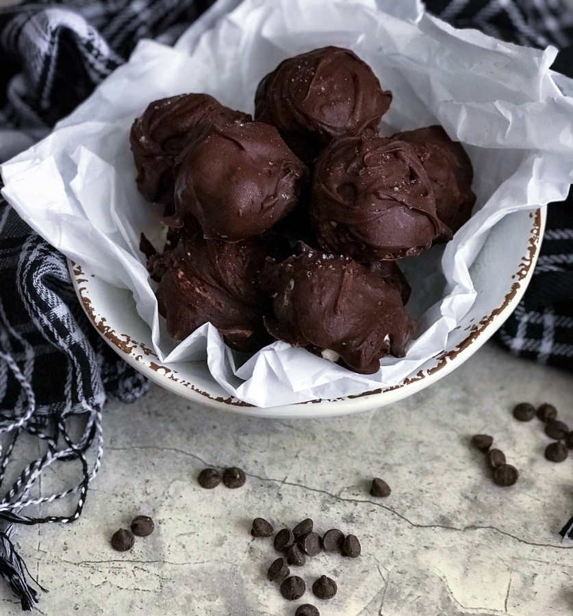 These mouth watering sugar-free cheesecake truffles are low carb, keto, and gluten free. Satisfy your sweet tooth with these easy-to-make chocolate covered truffles!