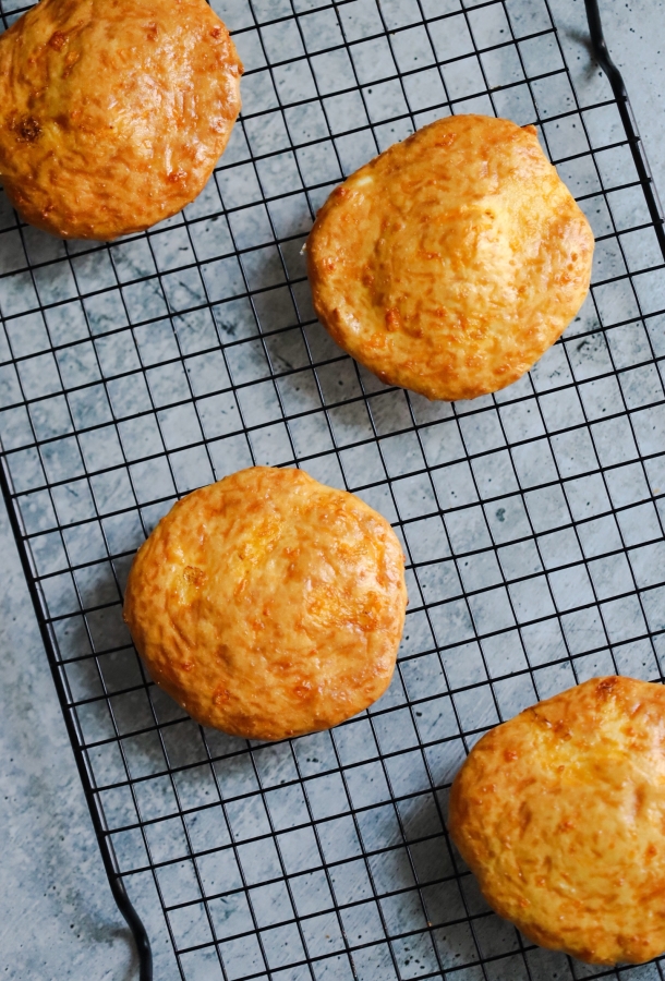 The Best Keto Buns - Shape your buns the way you want for burgers, hot dogs, and tacos. Keto Buns that actually taste good! #ketobuns #ketobread #ketobun #ketorecipe #lowcarbbread #lowcarbbuns | buttertogetherkitchen.com top view of the keto buns on a cooling rack
