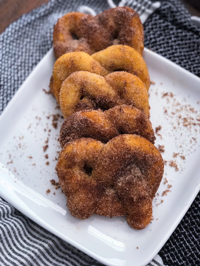 cinnamon sugar pretzels lined up together on a plate 