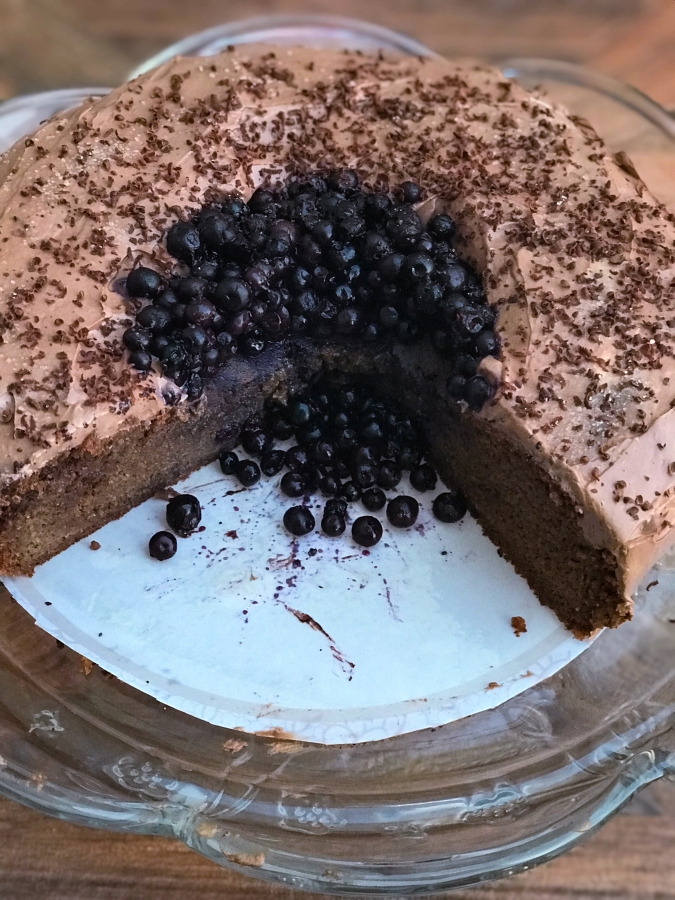 blueberry cake with two slices taken out of it
