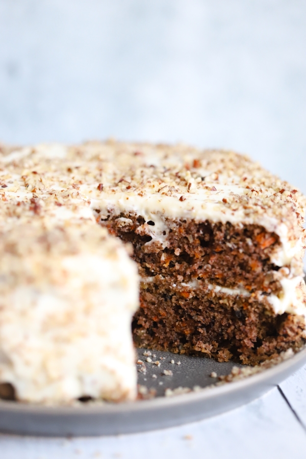 Close up of the inside of the carrot cake showing a slice taken out of it