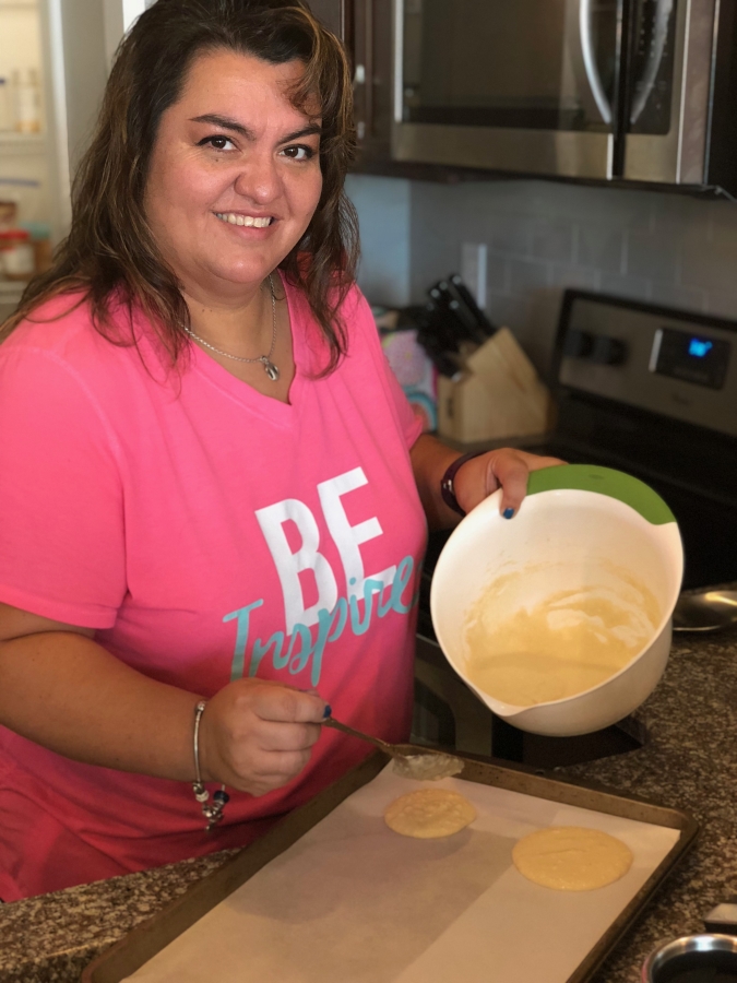 picture of my mom pouring pancake batter into a sheet pan to make keto pancakes