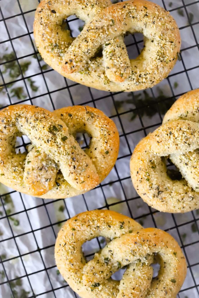 top view of garlic parmesan keto pretzels, close up showing four pretzels on a cooling rack