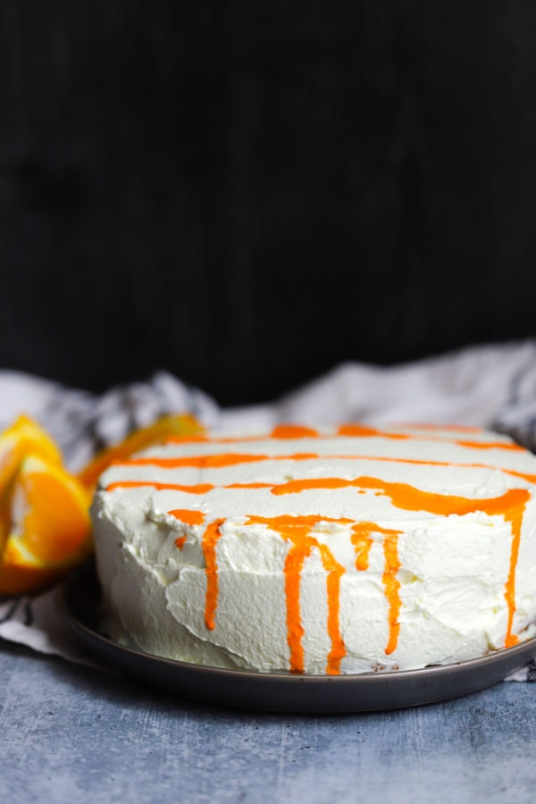 photo of the an unsliced orange creamsicle cake