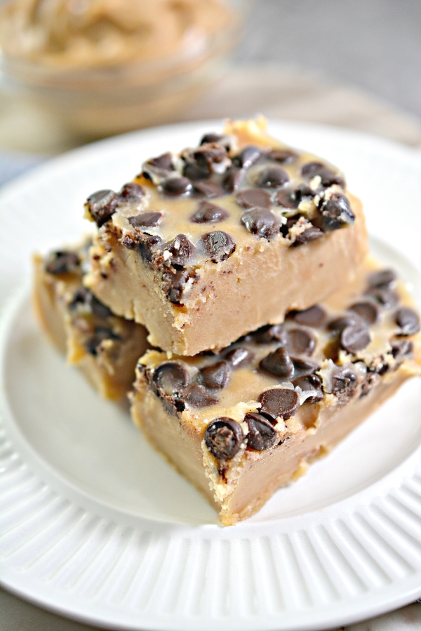 close up image of peanut butter fudge with two on the bottom and one piece of fudge stacked on top