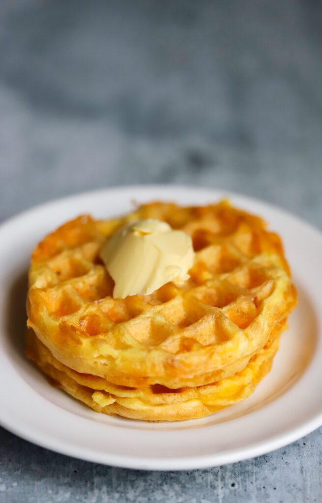 plain keto chaffles with one on top of the other and butter on top