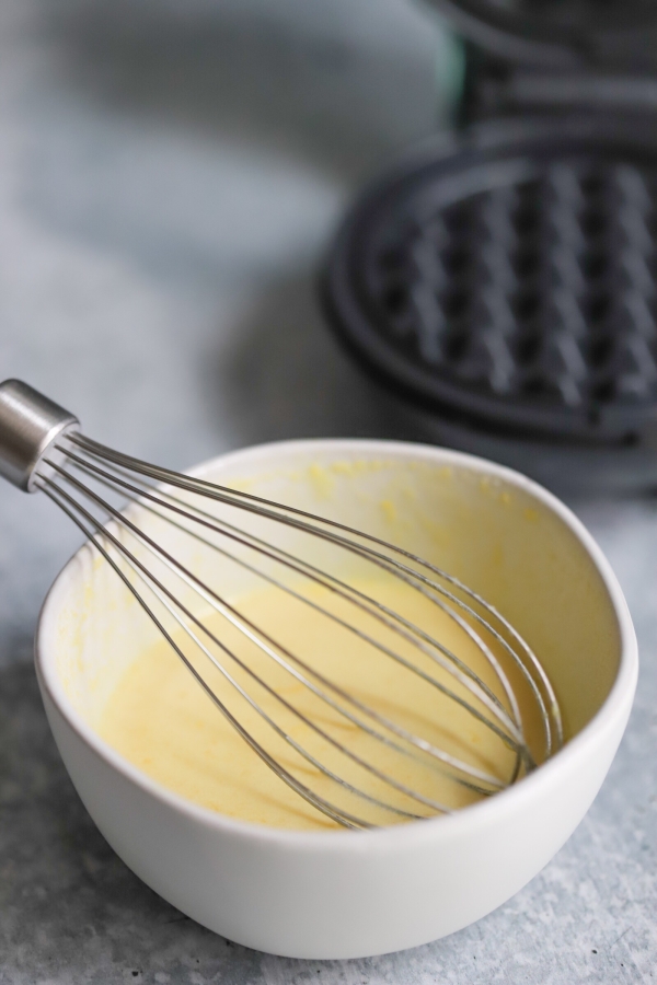 chaffle batter in a bowl with a whisk in it