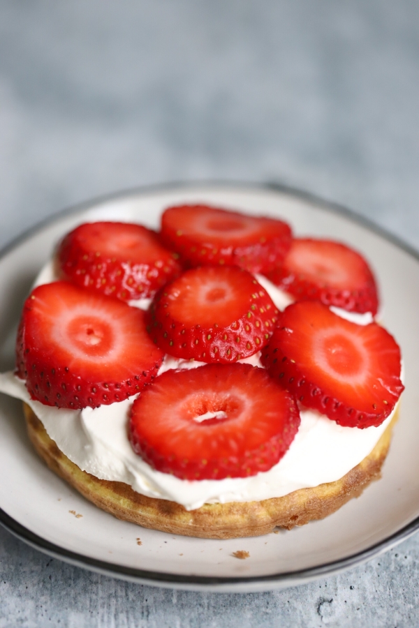 chaffle with whipped cream and strawberries on top, creating the middle layer