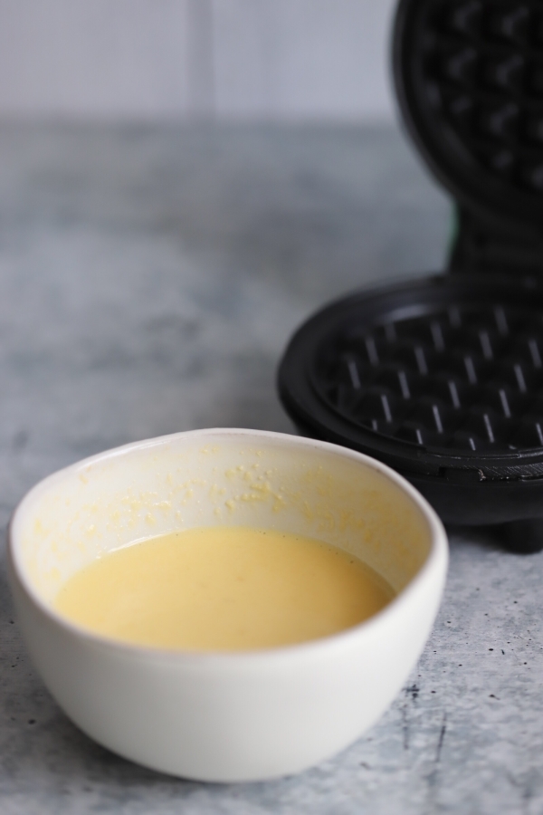 a mini waffle maker with batter in it