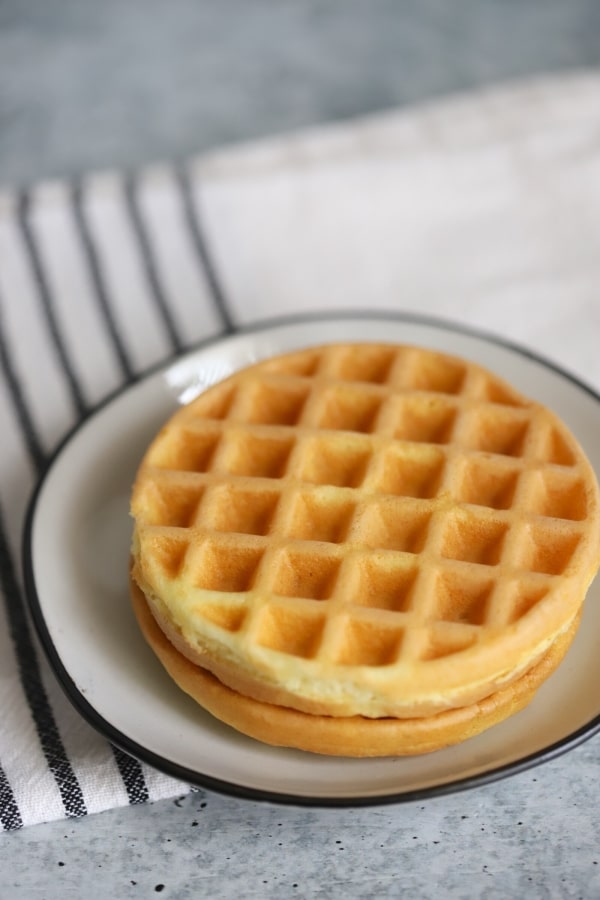 two plain white bread chaffles on a plate
