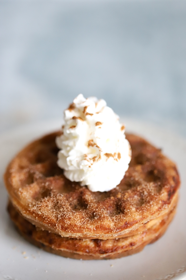 close up of snickerdoodle chaffles with whipped cream on top