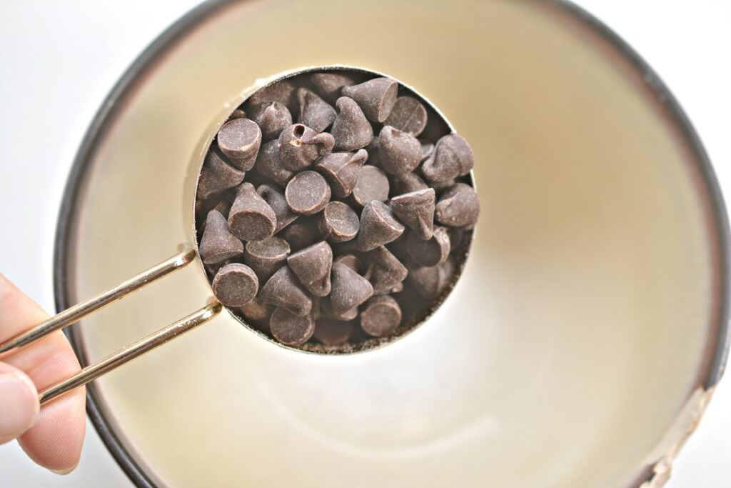 adding chocolate chips in a microwave safe bowl
