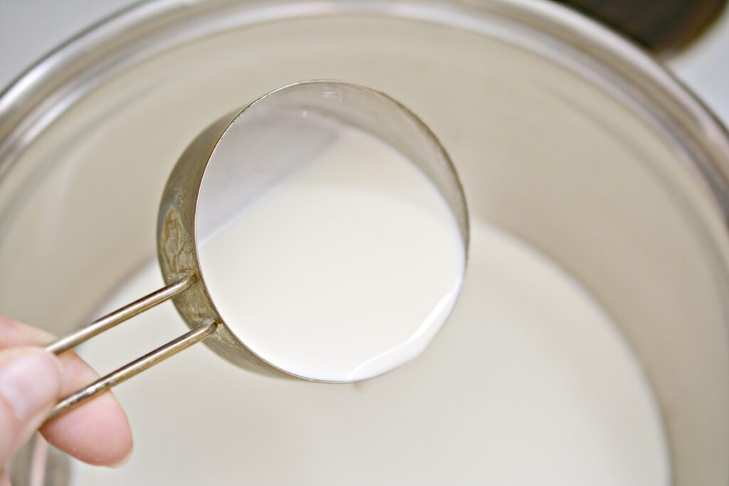adding heavy cream in a stove top pan