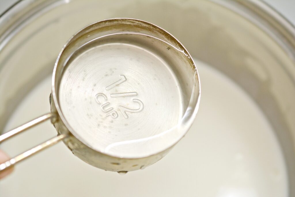 adding water into a stove top pan