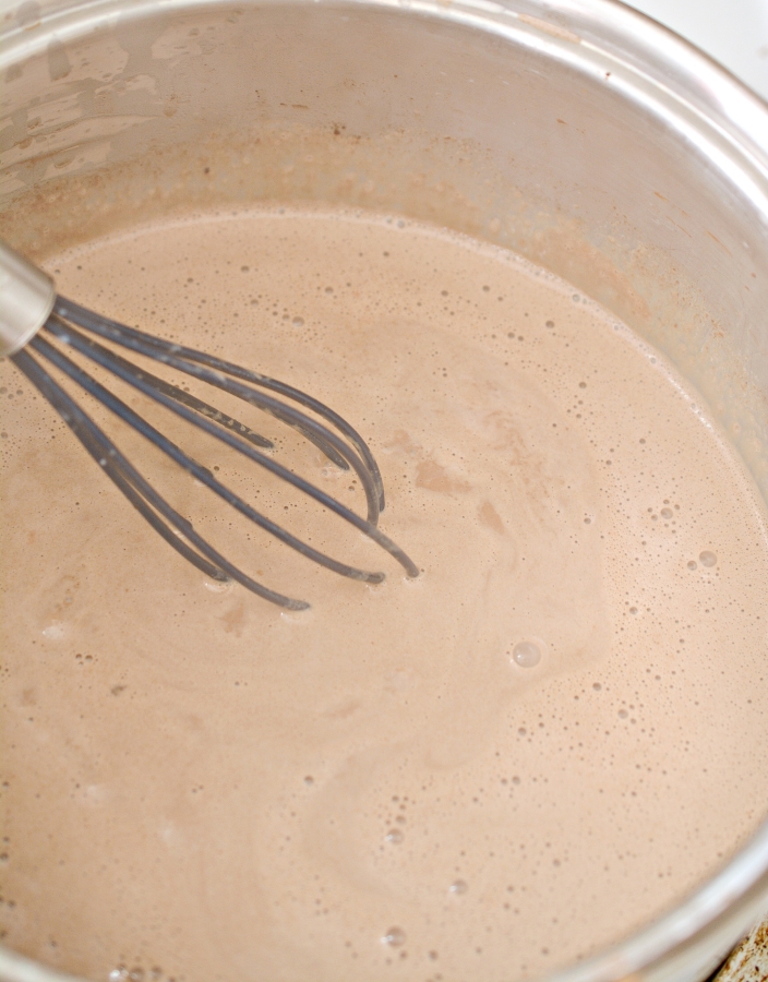 whisking the hot chocolate in the stove top bowl
