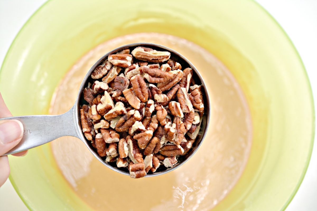 1 cup of chopped pecans over a mixing bowl