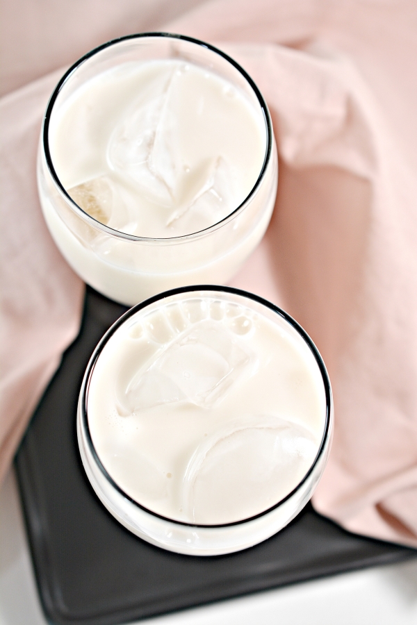 top view of two glasses of almond milk with ice 