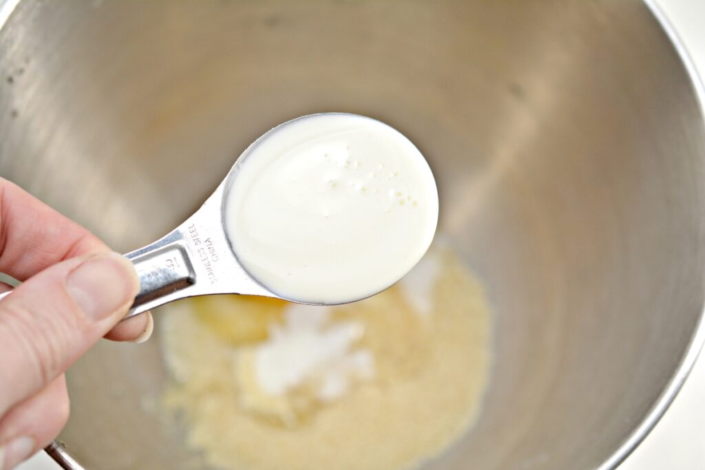 heavy cream in a tablespoon over a mixing bowl