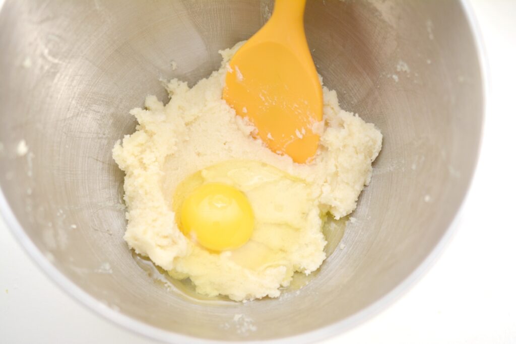 adding eggs into mixing bowl