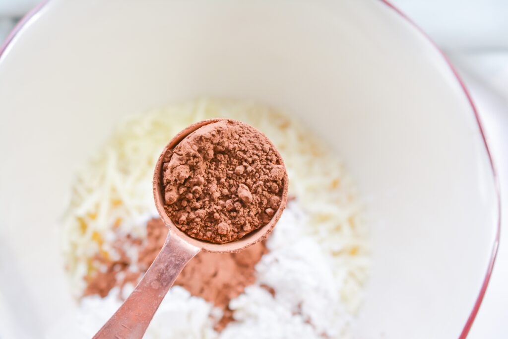 tablespoon of cocoa powder over a mixing bowl