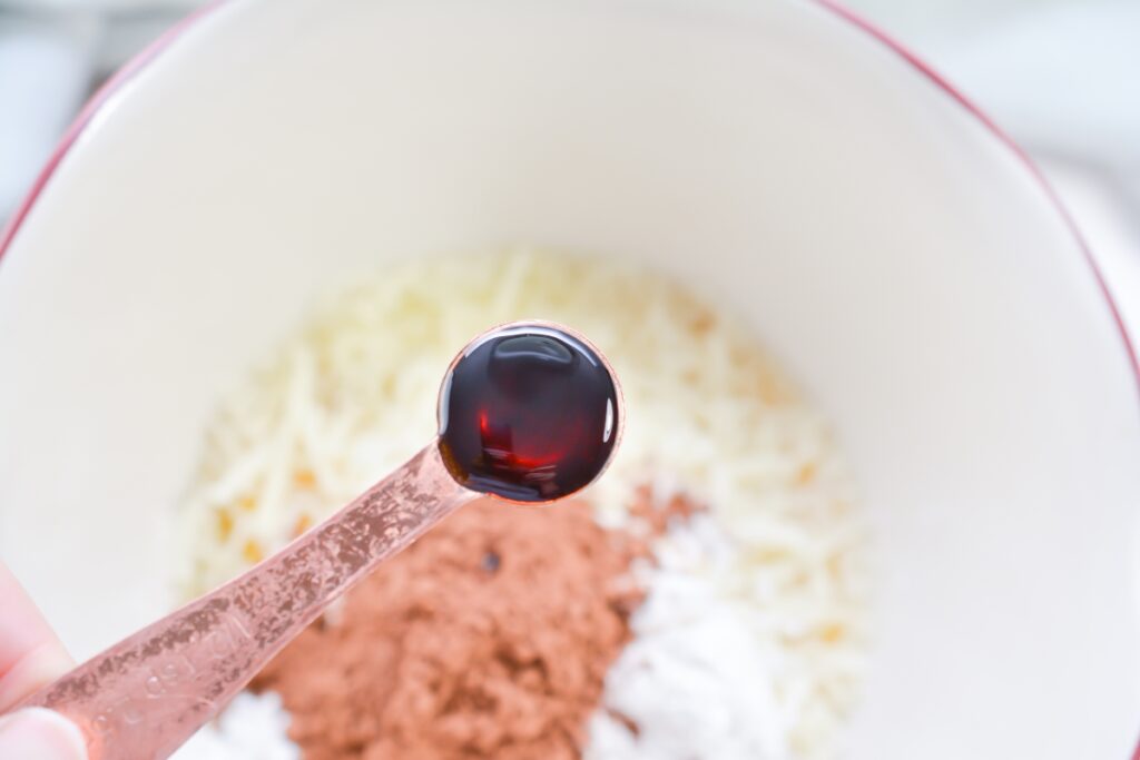 tsp of vanilla extract over a mixing bowl