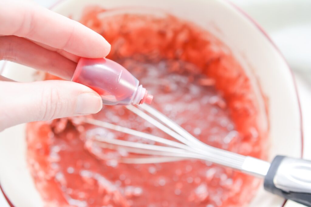 pour a drop of food coloring over a mixing bowl