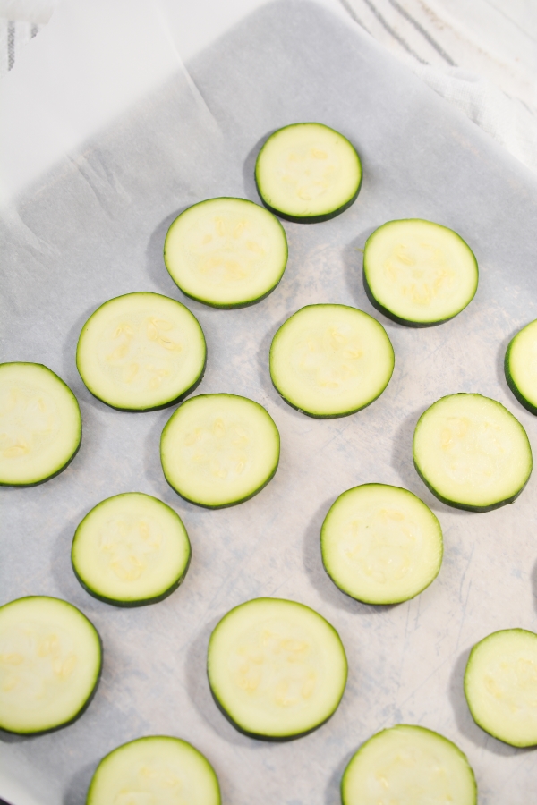 sliced up zucchini on a sheet pan 