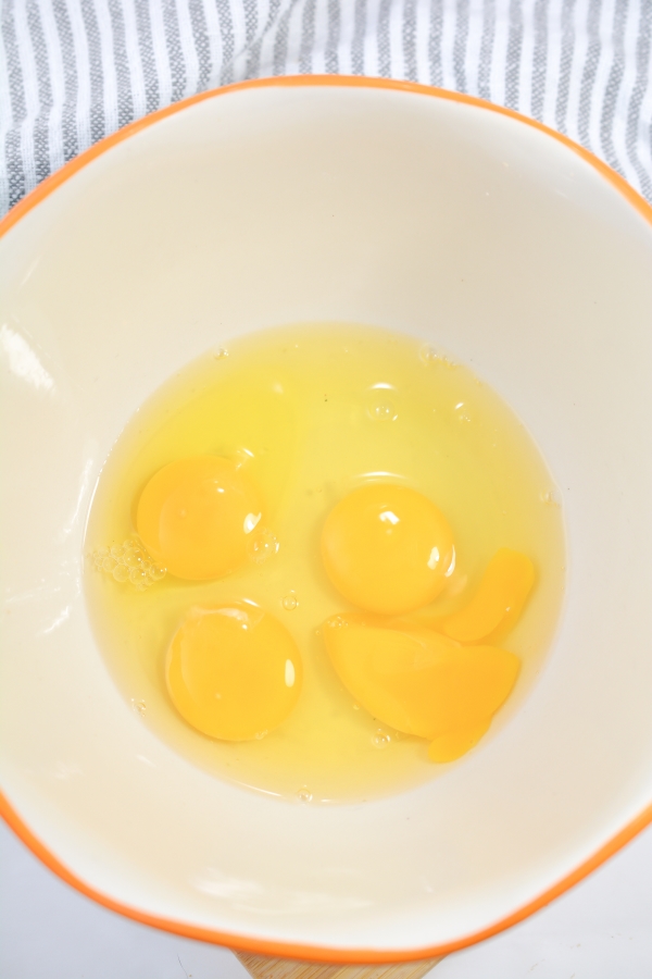 four eggs in a mixing bowl