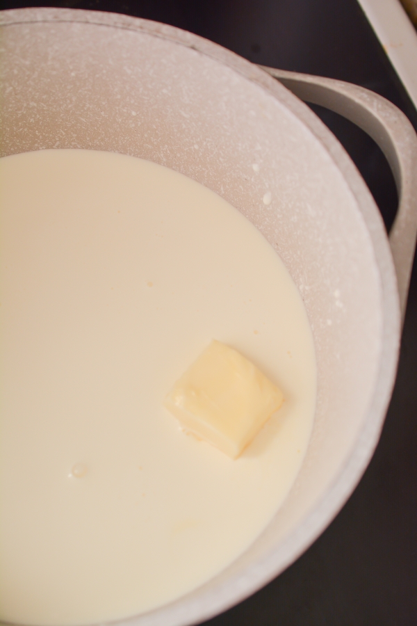 heavy cream and butter melting in saucepan