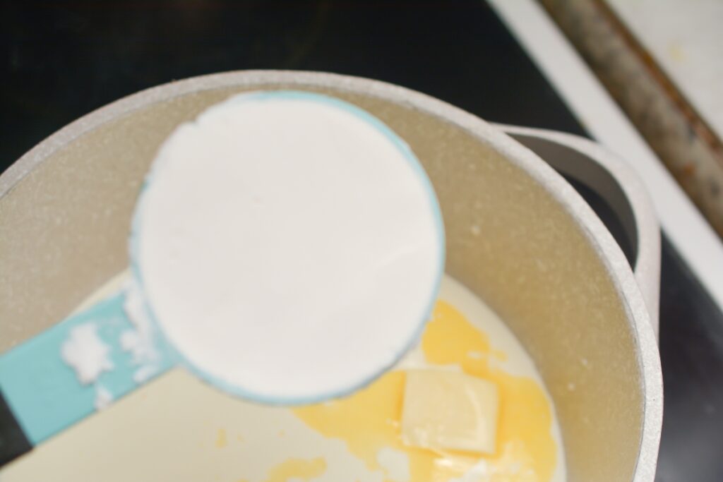 sweetener in measuring cup going into saucepan