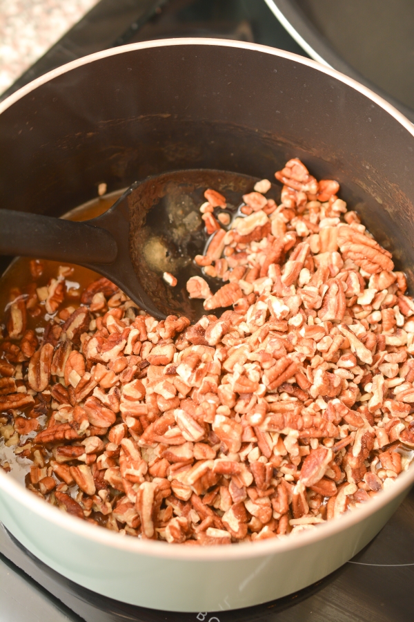 stiring the pecans and butter in a pot