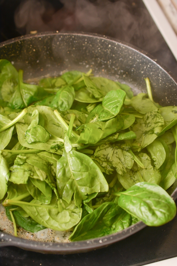 spinach being cooked in pan