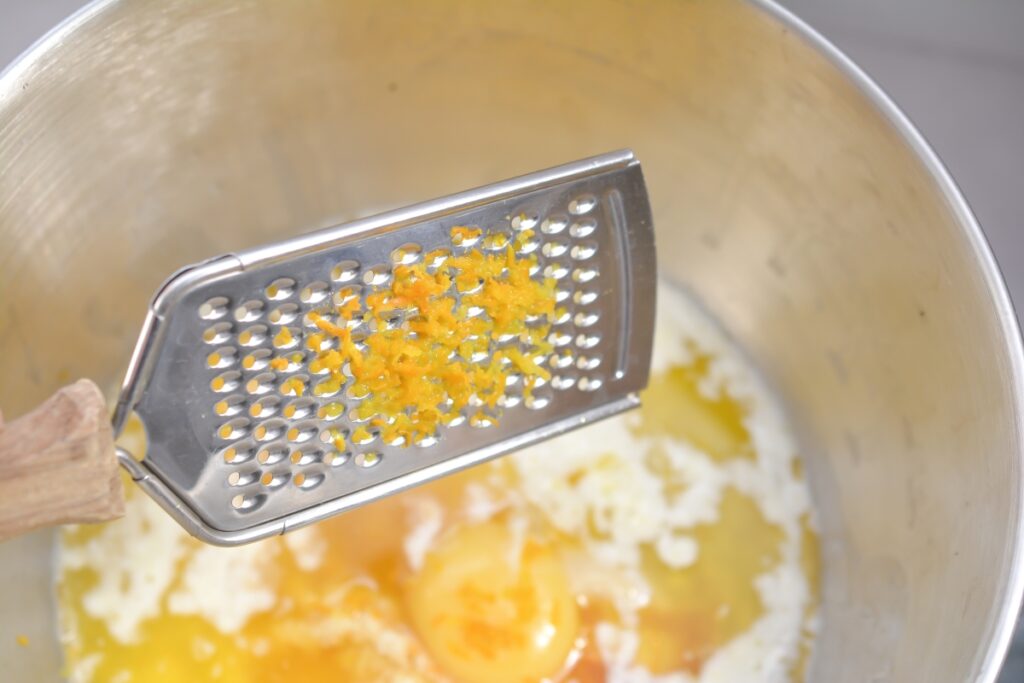 lemon zest being adding to mixing bowl