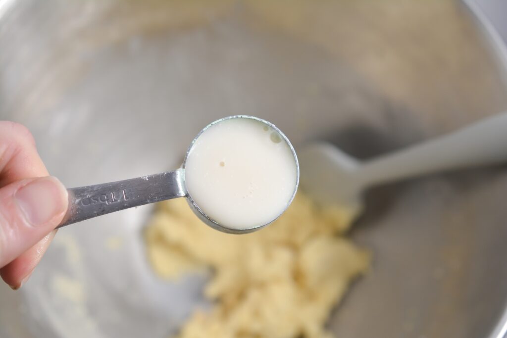 almond milk in a tablespoon over a mixing bowl